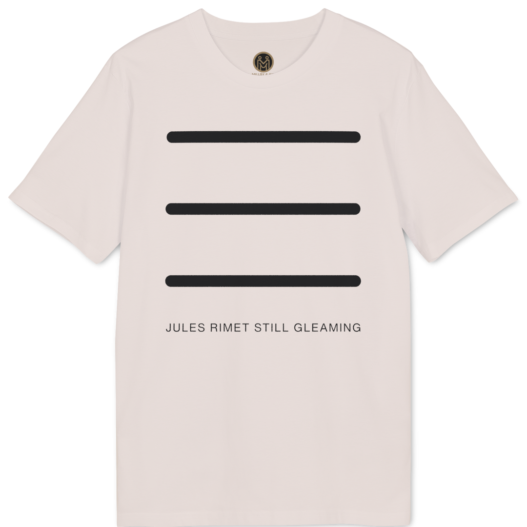A light pink short-sleeve t-shirt with three horizontal black bars on the front and the text 'JULES RIMET STILL GLEAMING' printed below. A small circular gold logo is visible inside the collar.