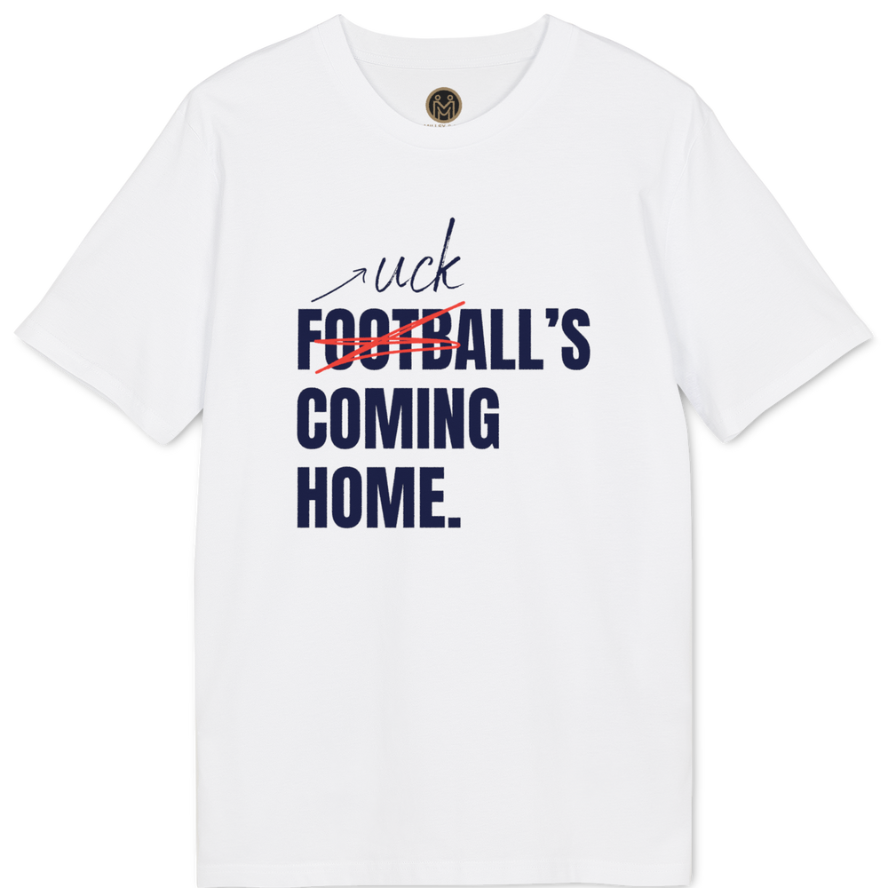 A light pink short-sleeve t-shirt with a graphic print on the front. The graphic features the word 'uck' in black script, the word 'FOOTBALL' in bold navy blue text crossed out with a red scribble, and 'COMING HOME.