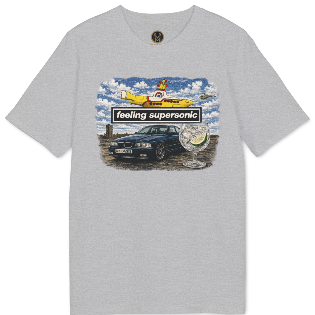 A light gray heather crewneck t-shirt featuring a colorful graphic print on the front with a yellow airplane, a black car, and the text &
