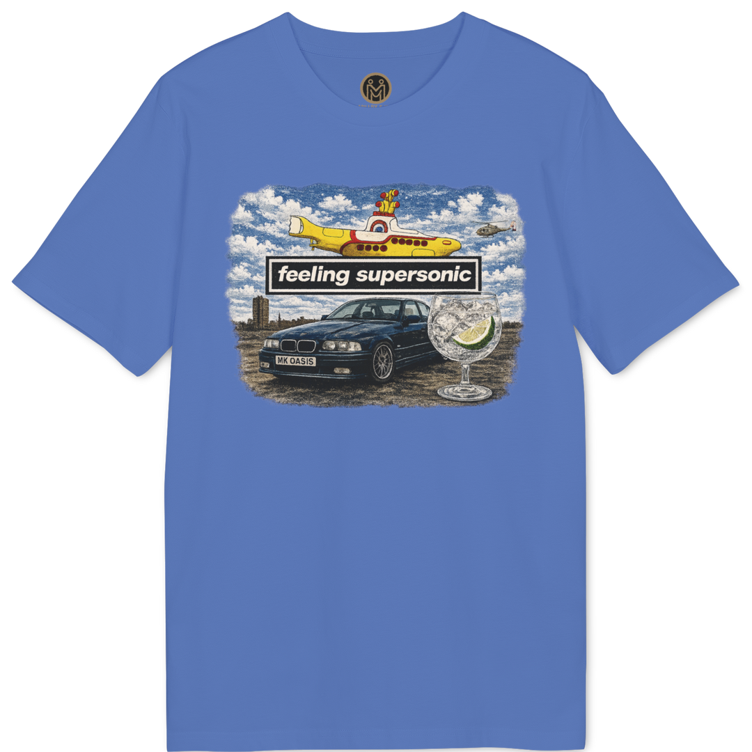 A blue short-sleeve crewneck t-shirt featuring a colorful graphic print on the chest. The graphic depicts a yellow subterranean vehicle, a black car, a road sign reading &